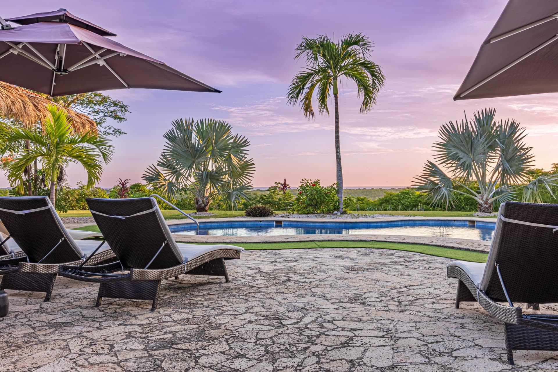 Pool area at sunset with ocean views